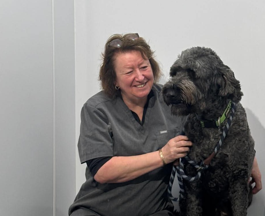 Portrait of Tracey with a dog in the salon